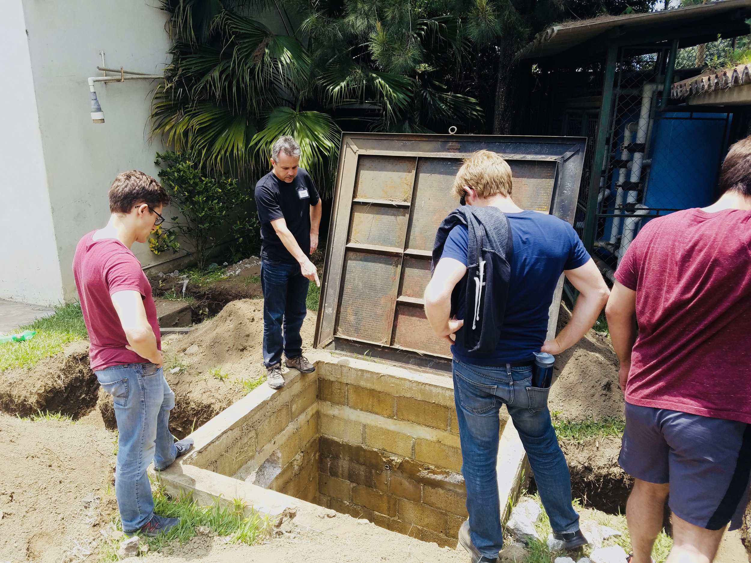 Members survey the water storage system during the 2017 Guatemala Project implementation trip.