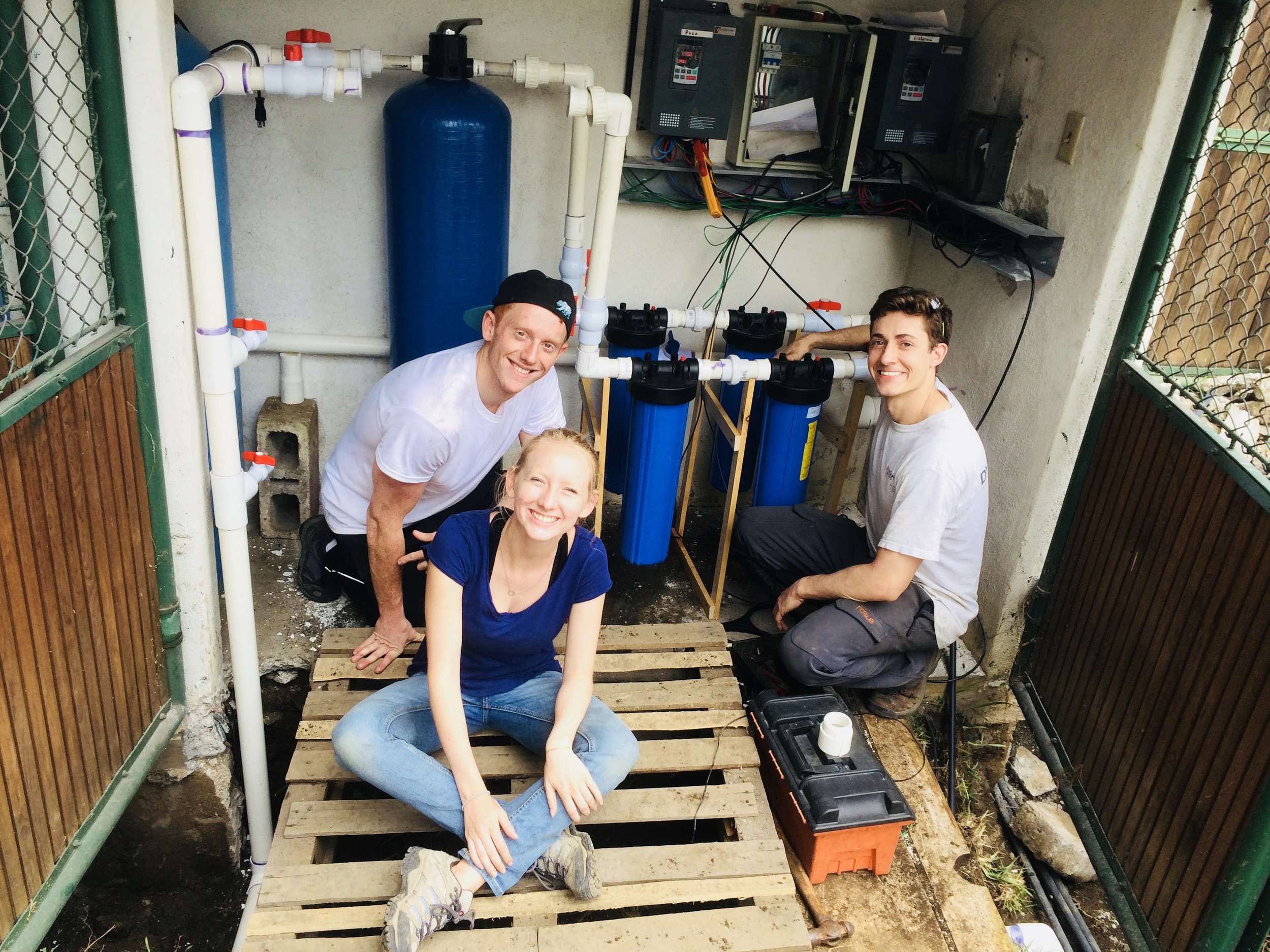 Students work on the water filtration system at the Common Hope campus in Antigua. 