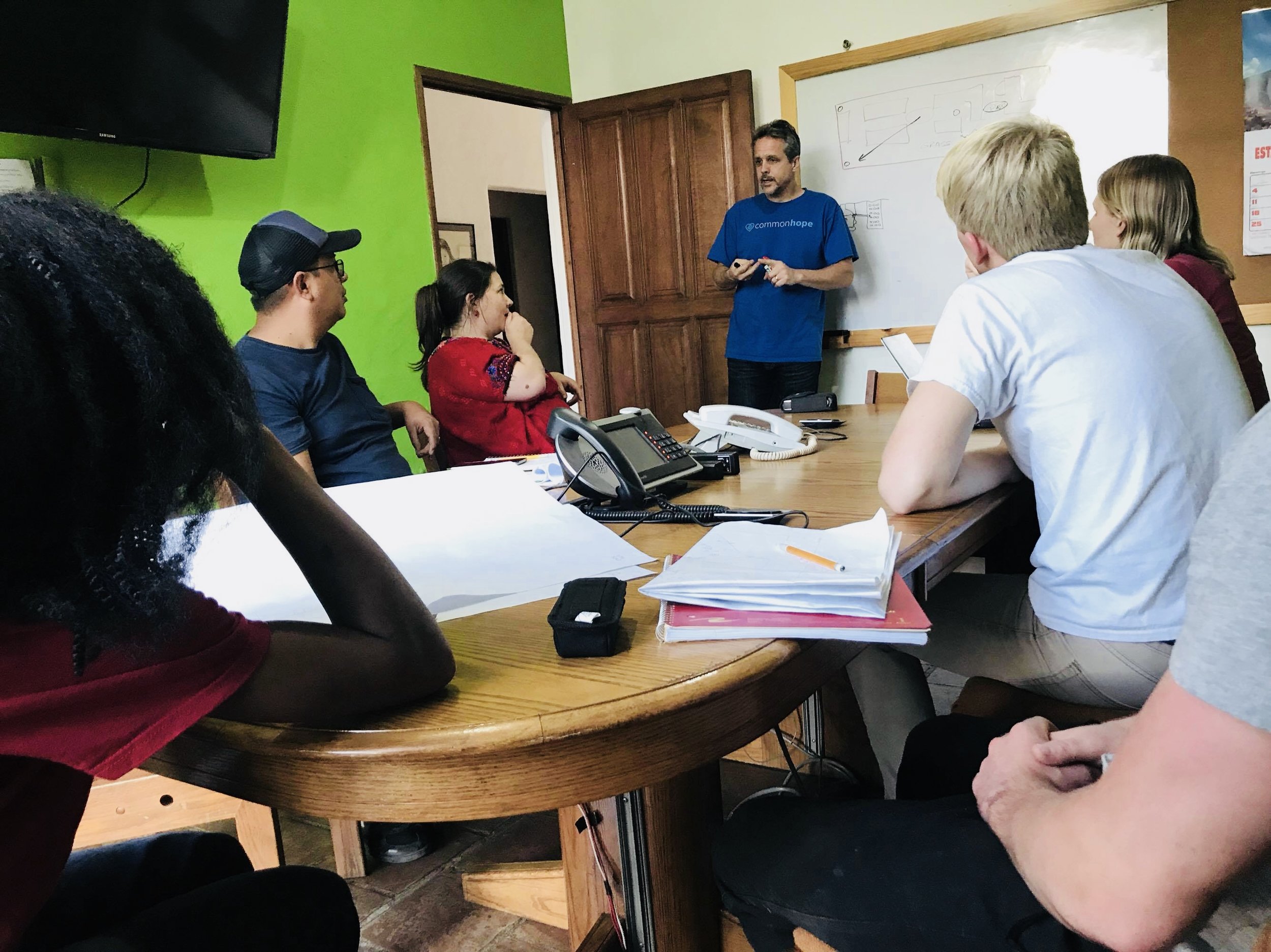 Travel team members discussing with mentor Peter Kraut during the February 2018 assessment trip in Antigua. 