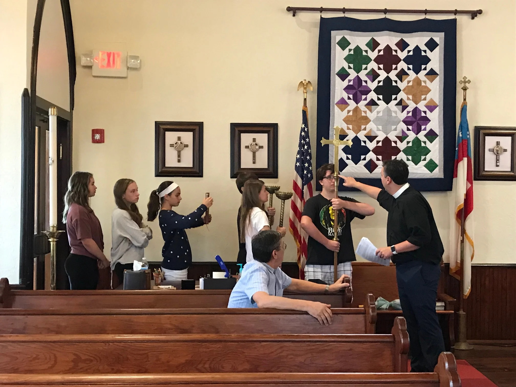 Fr. Greg trains new and veteran acolytes in how to process in worship. August 18, 2019. Photo by Robyn Flowers.