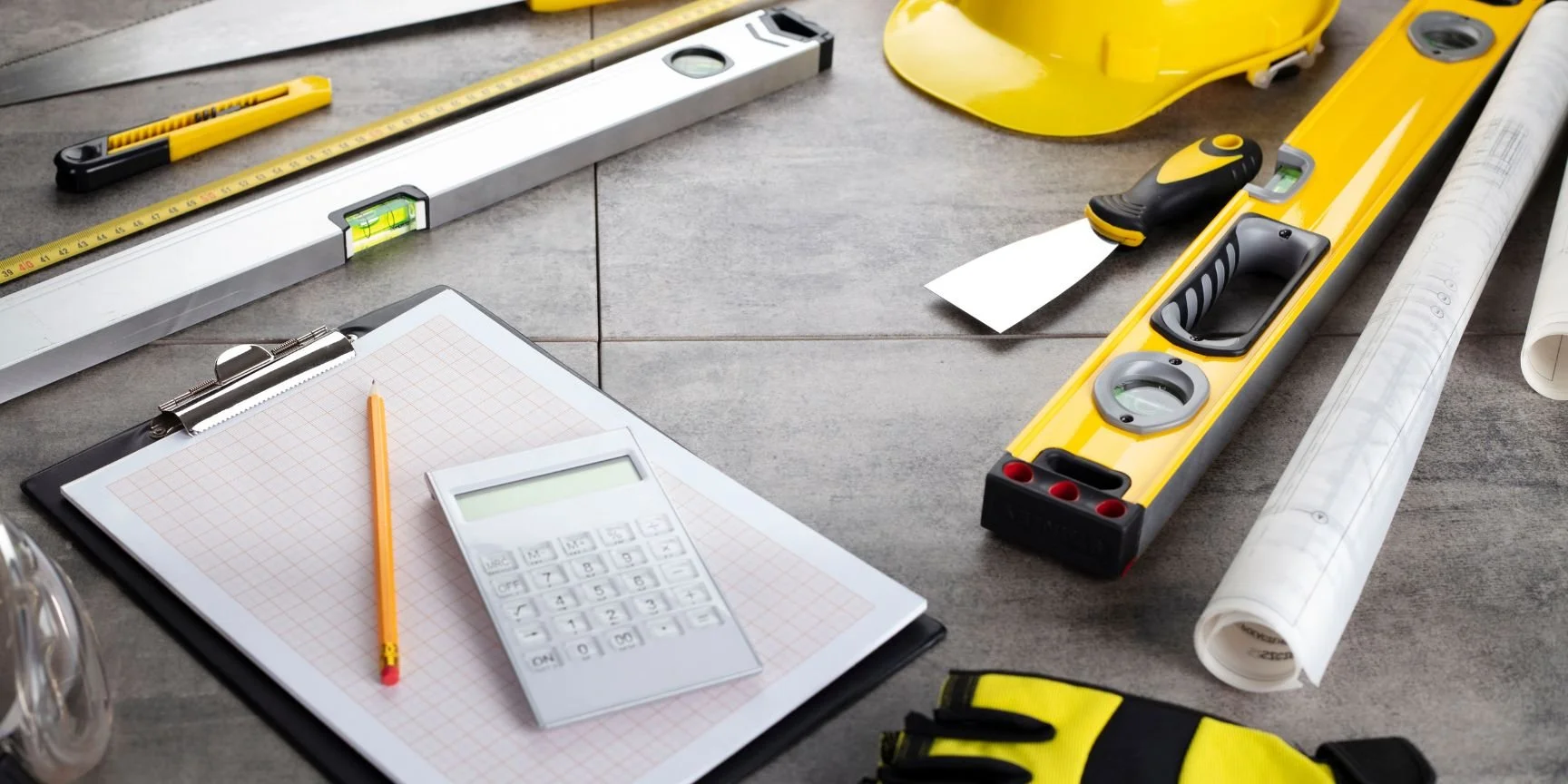 home contractor tools spread out on a tile floor