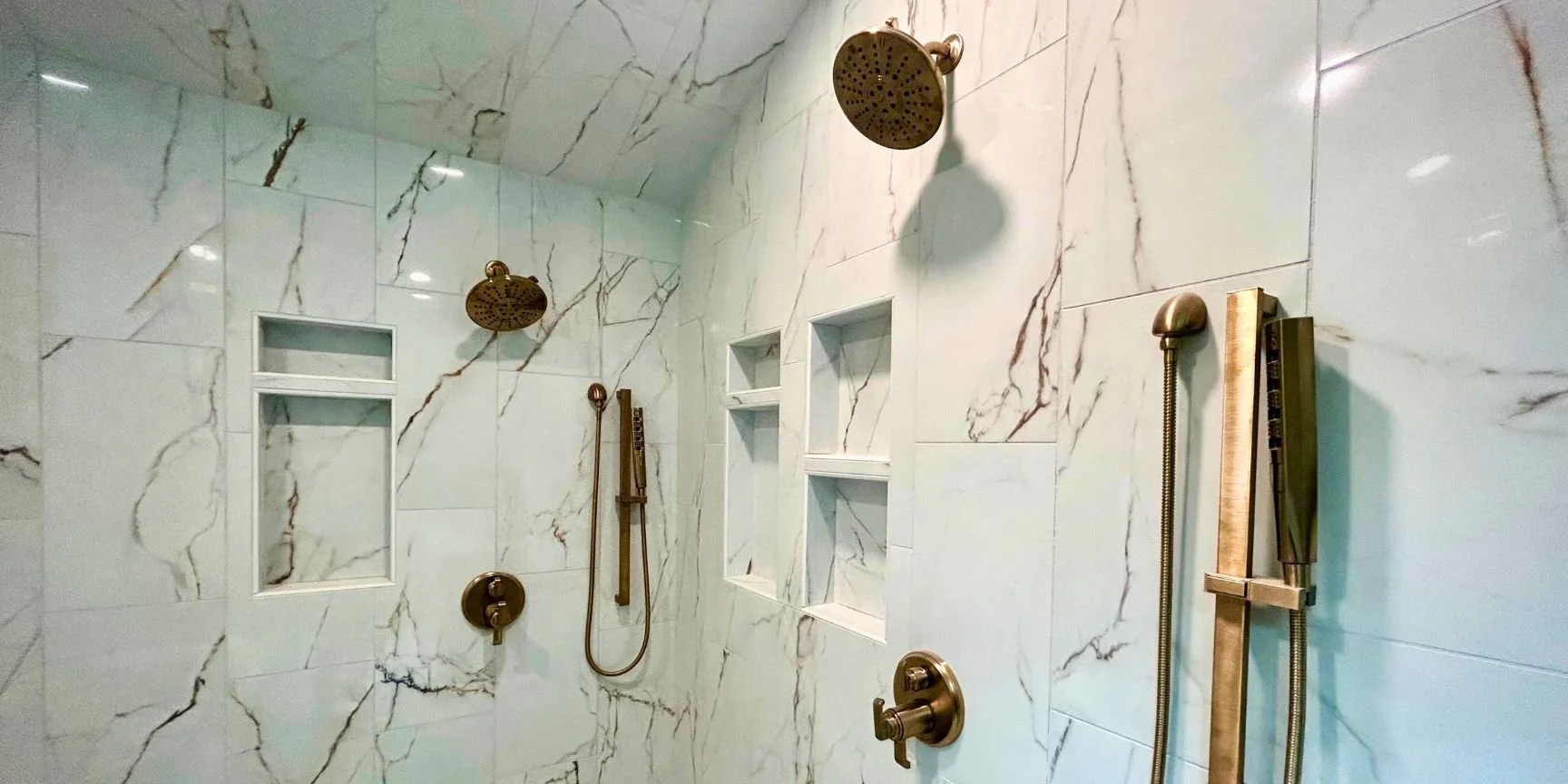 New shower heads and marble tiling as part of a shower remodel knoxville