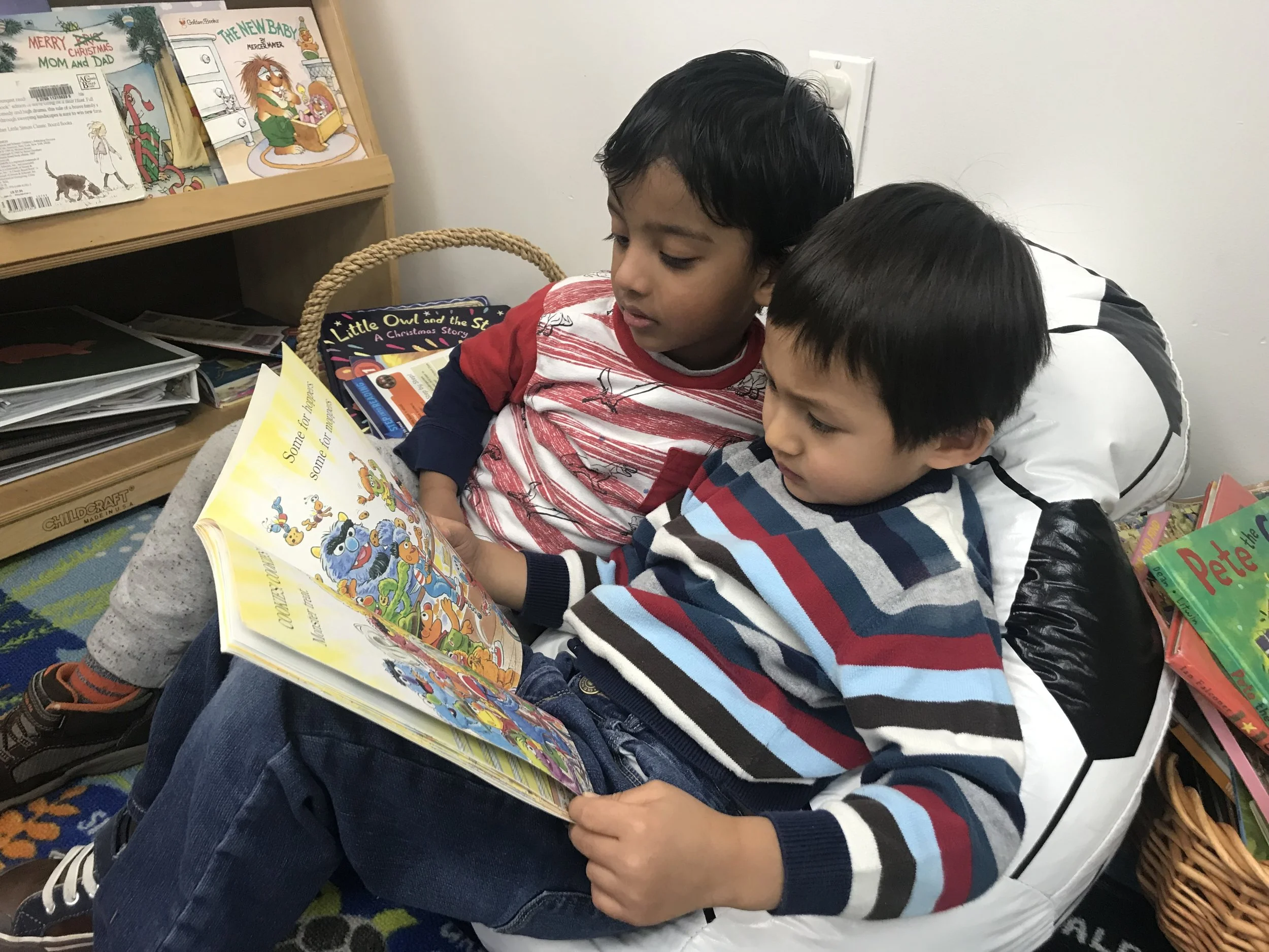 Two children reading a book together