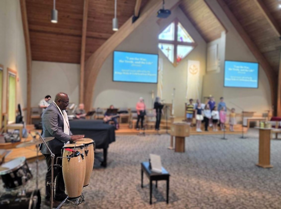 Pastor Elijah of King of Kings playing drums
