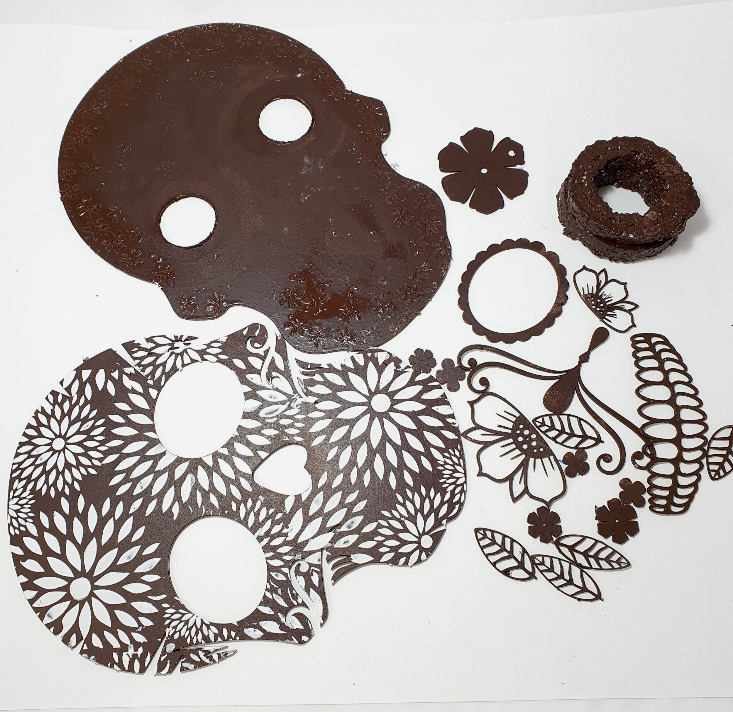 Step 2. Bronze up & stencil - I planned to put the lights in for the eyes, so I first marked out where I would be cutting the holes in the back piece to slide the tealights in from the back - Make sure you stir your Powertex Bronze Liquid well - Stencil your preferred pattern on the skull face - Paint all the bits back & front, leaving to dry each side before doing the other side - I also cut 4 rounds of styro foam to place between the back & front to have a gap to fit the tea lights in. Bronze them up too.