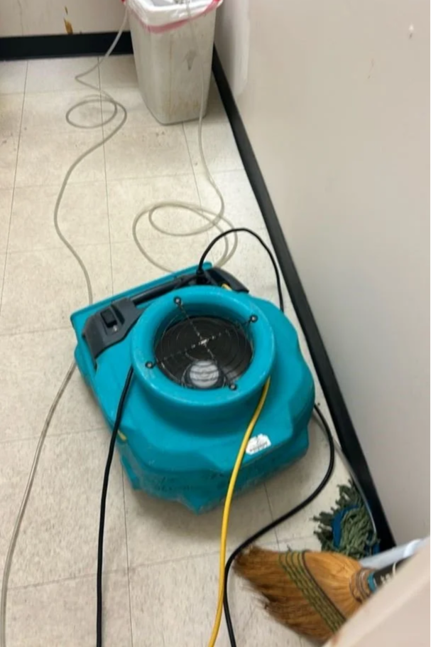 ServiceMaster equipment drying bathroom floor