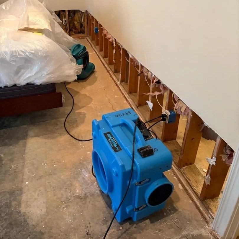Damaged drywall and carpet removed from basement bedroom