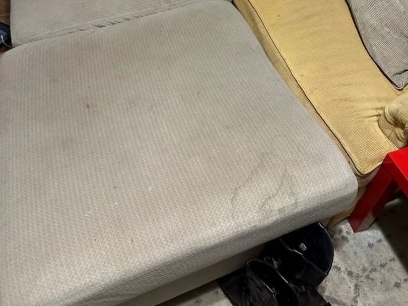 Ottoman before ServiceMaster upholstery deep cleaning