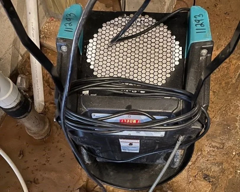 ServiceMaster dehumidifier drying crawlspace after water main break in yard