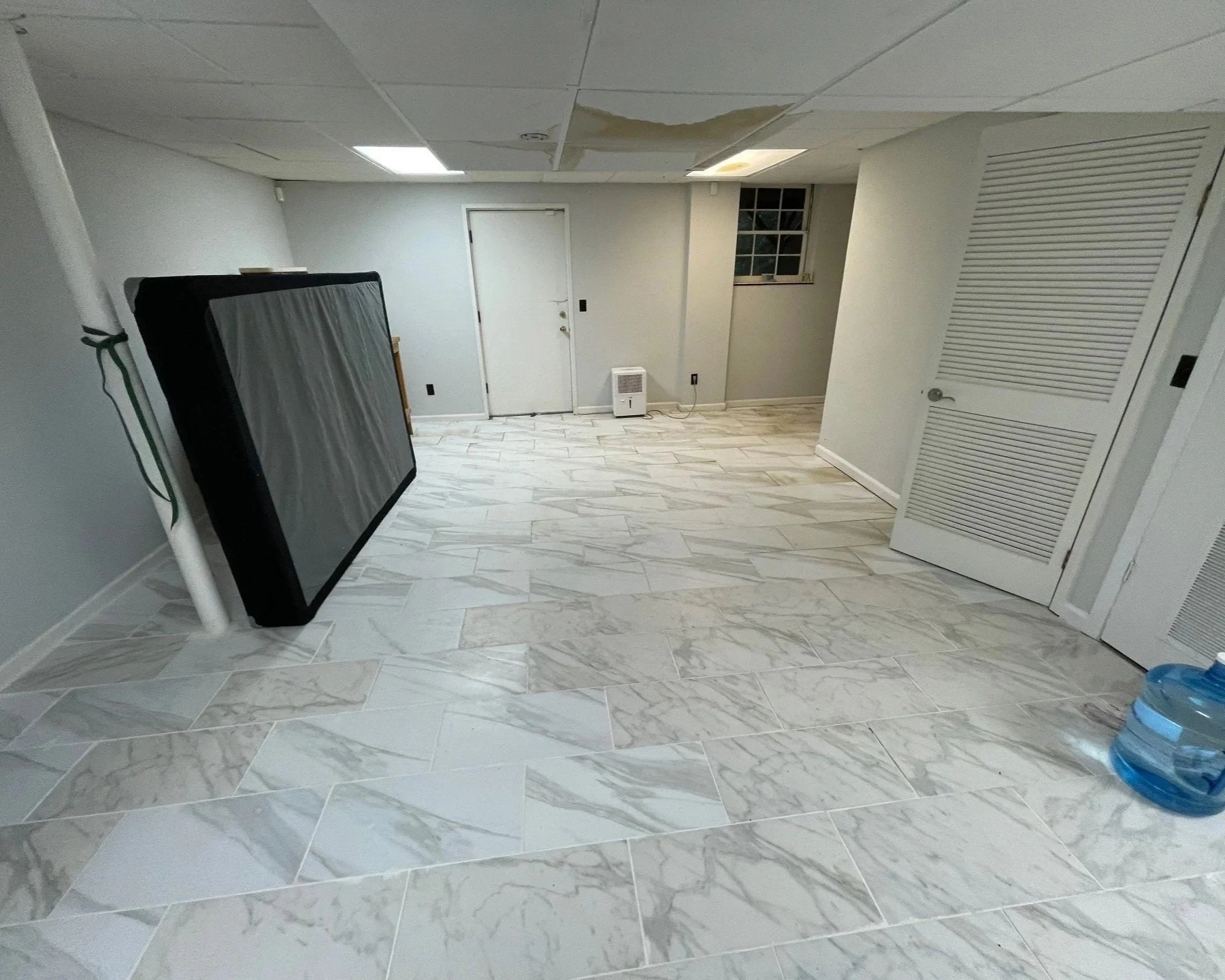 CAT 3 contaminated water in the ceiling dripping onto the basement tile floor