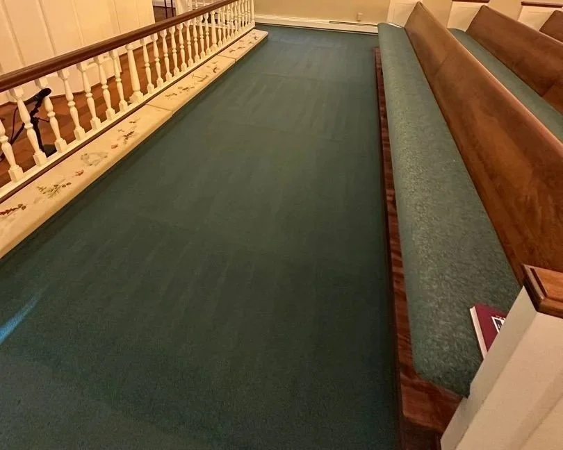 Carpet across the front of the right side pews in the sanctuary after a ServiceMaster professional carpet cleaning