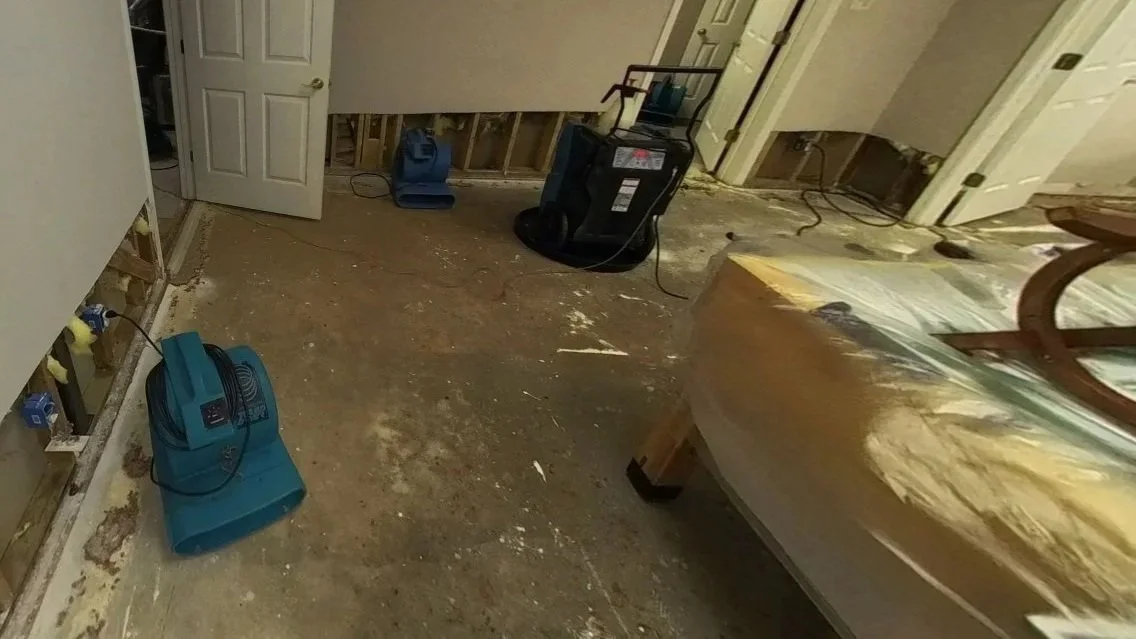 Pool table covered while damaged carpet and drywall removed and drying equipment set to dry basement game room
