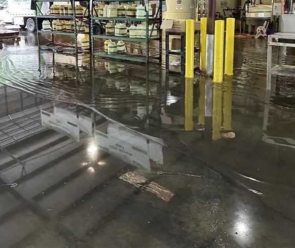 Waves in water on warehouse floor after water loss