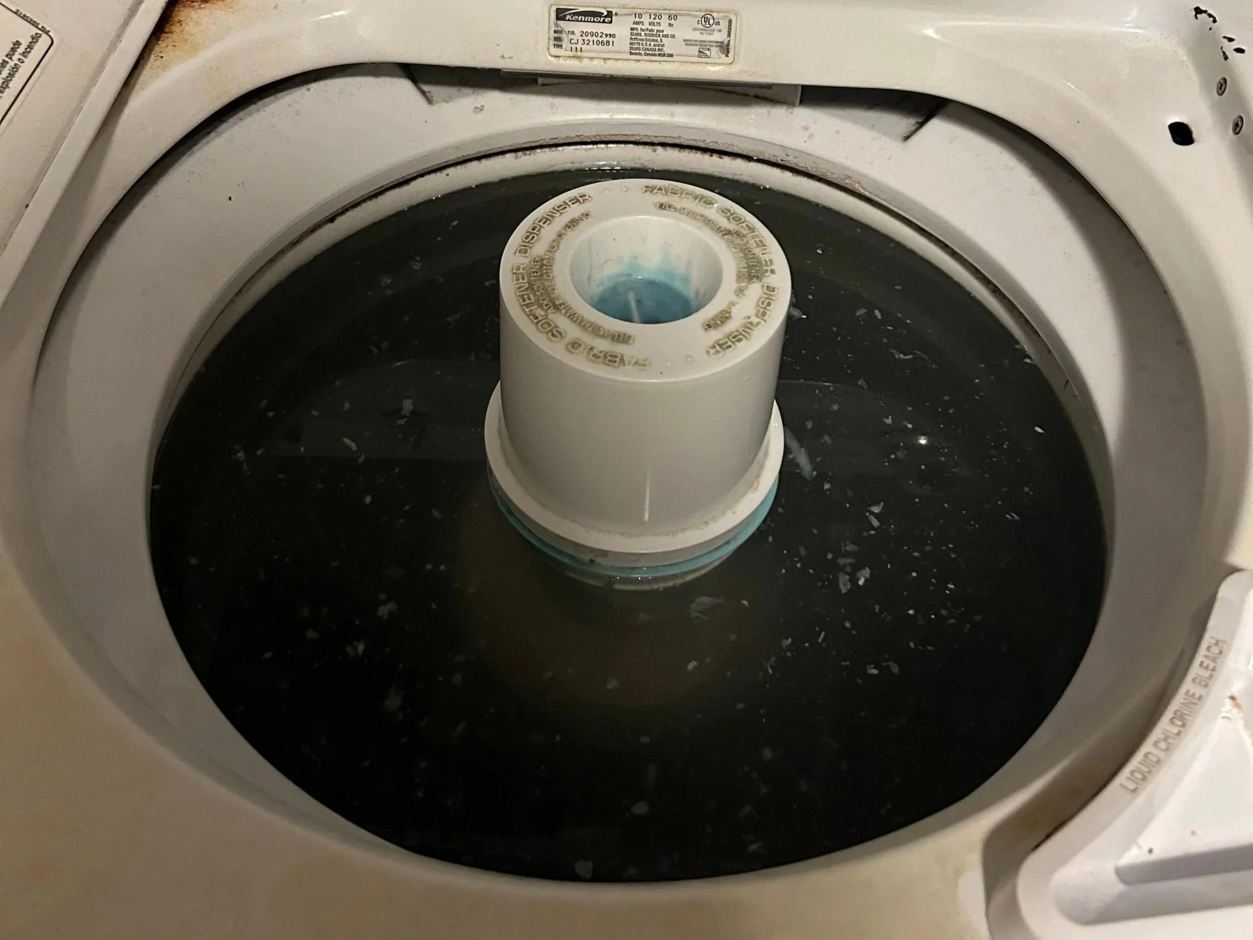 A washing machine full of dirty water after an overflow caused water damage