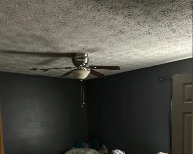 Bedroom with smoke and soot residue damage from a space heater fire
