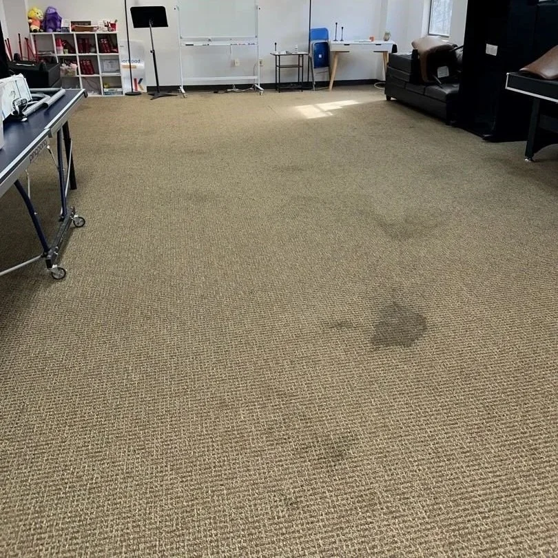 Classroom stains on the carpet before the ServiceMaster carpet cleaning service was performed
