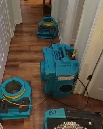 ServiceMaster set drying equipment during water damage mitigation in hallway