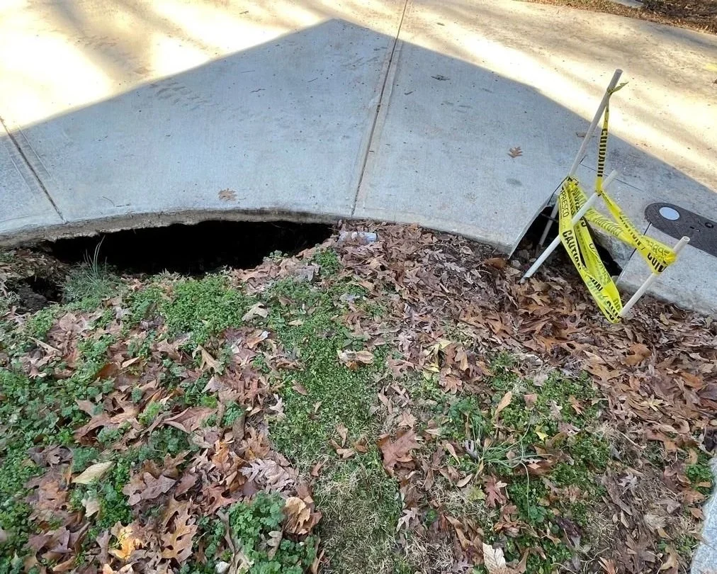 Ground under sidewalk after water main break that flooded customer's crawlspace