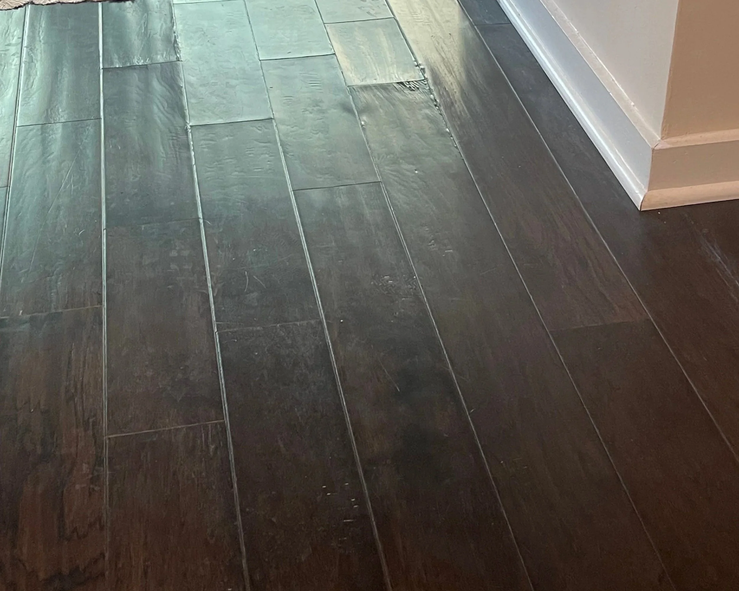 Damaged laminate flooring after a dishwasher leak