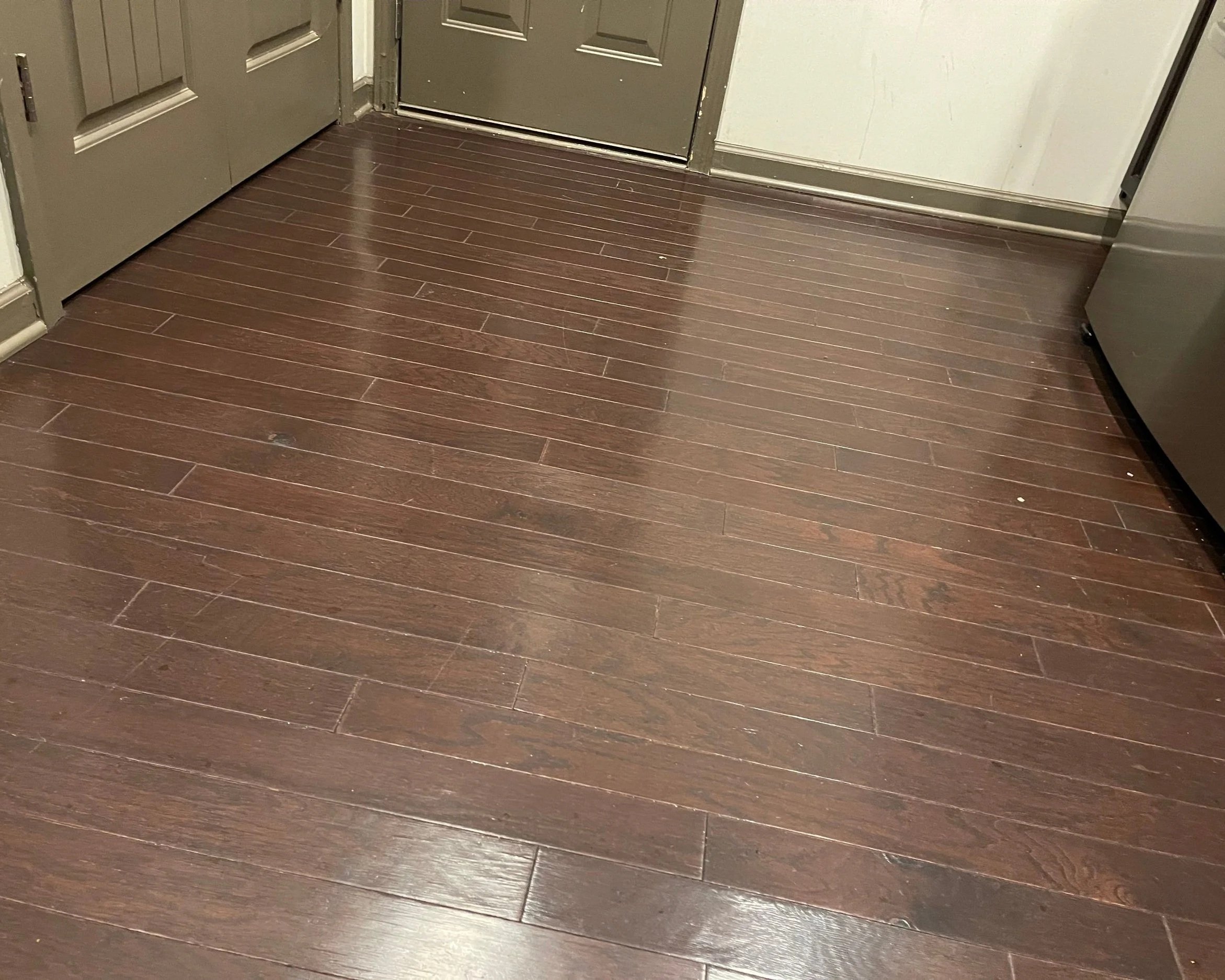 Kitchen hardwood flooring damaged after bathtub overflowed in bathroom above