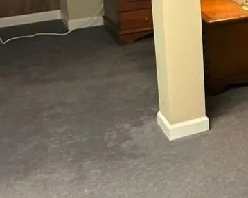 Wet carpet in basement den after heavy rain