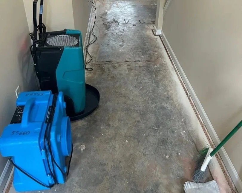 ServiceMaster removed saturated carpet and set drying equipment in hallway