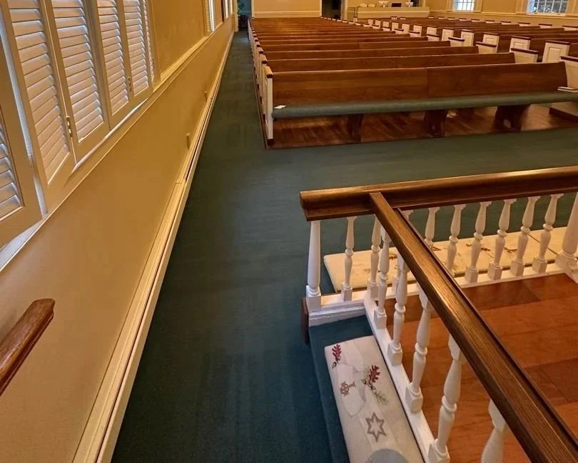 Carpet on the right side aisle looking toward the back after a ServiceMaster professional carpet cleaning