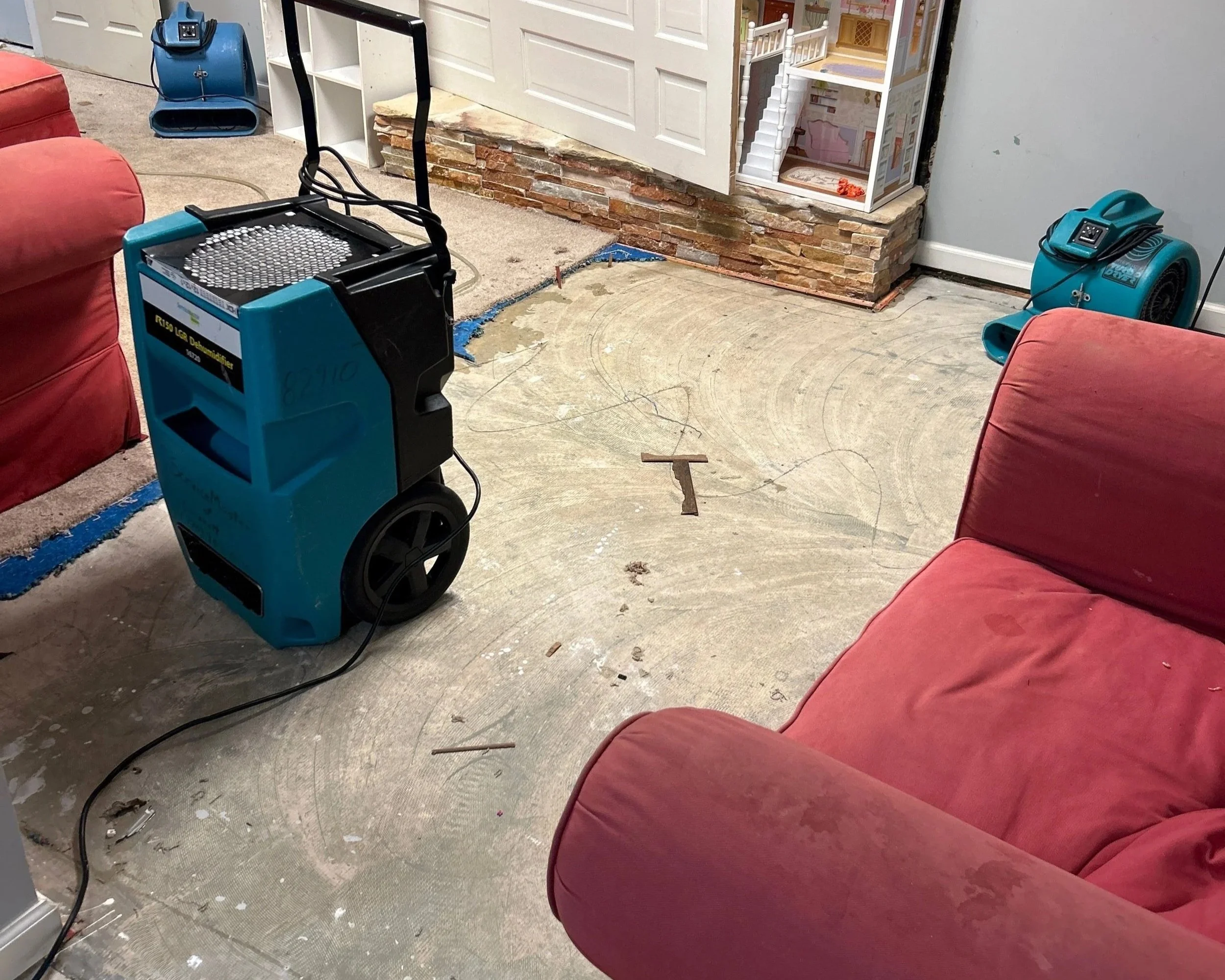 ServiceMaster extracted water from the living room, removed the damaged flooring and set drying equipment