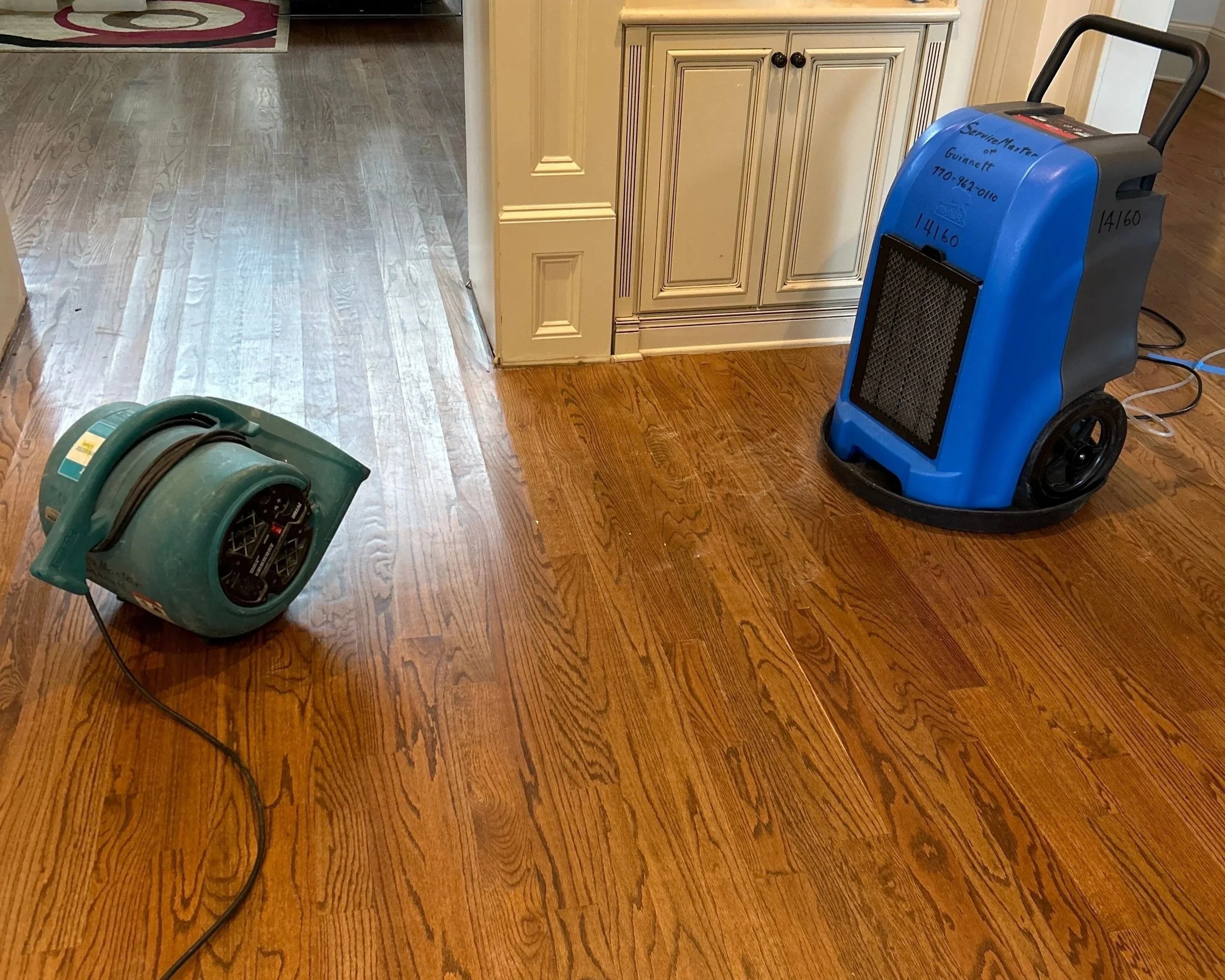 ServiceMaster set drying equipment in den after 2nd floor bathtub overflow