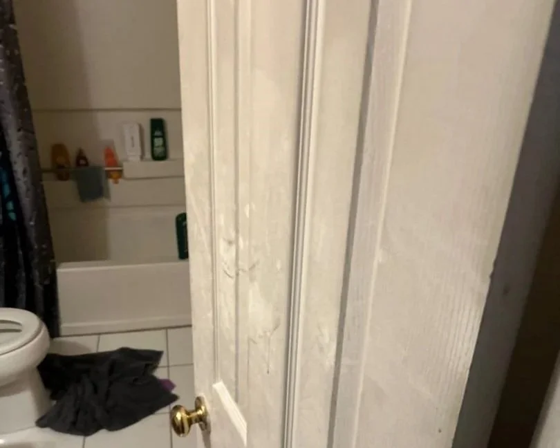 Bathroom door with soot damage after a space heater fire