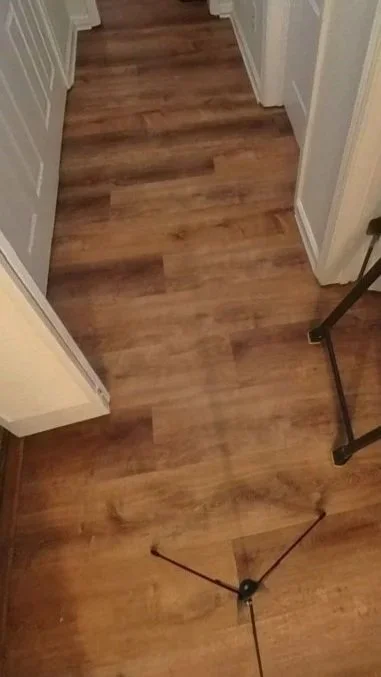 Hallway with water damage after water heater leaked in unit above