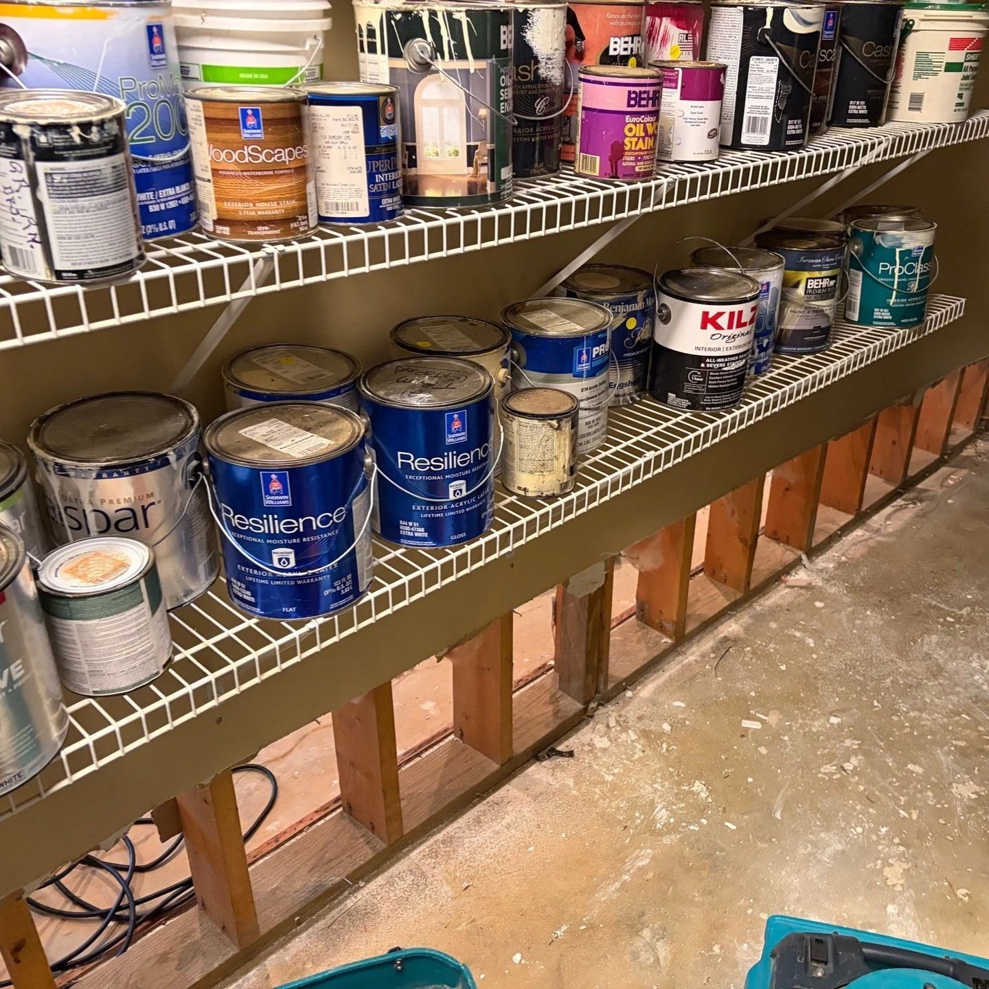 Damaged drywall removed from basement workshop wall