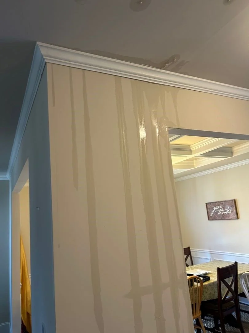 Water running across ceiling and down the wall after a pipe broke in the ceiling