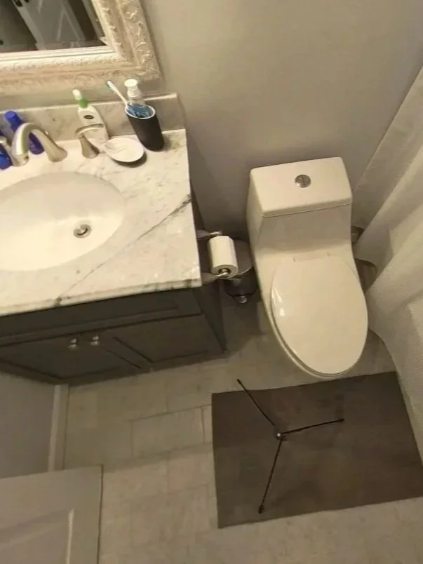Bathroom with water damage from water heater leak in unit above