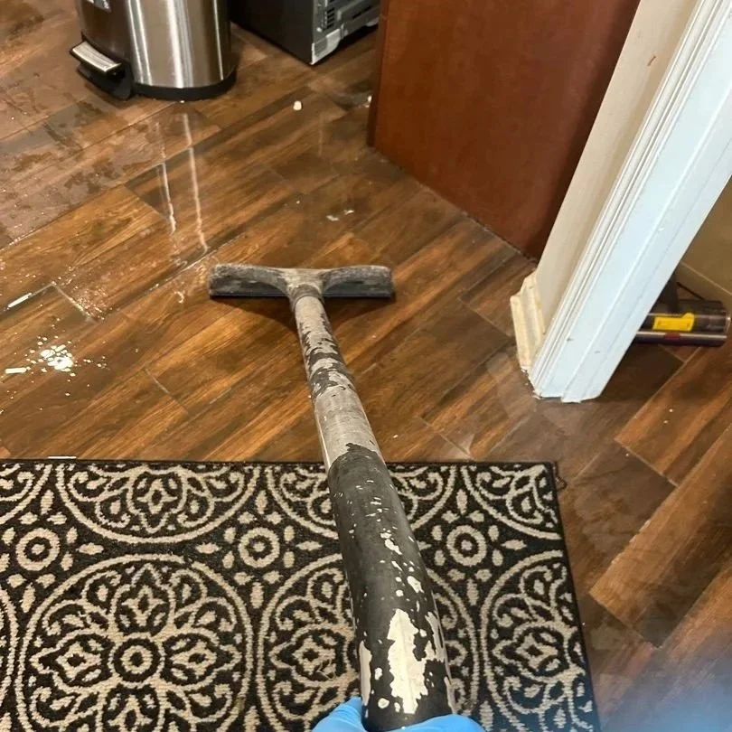 ServiceMaster technician extracting excess water from kitchen floor