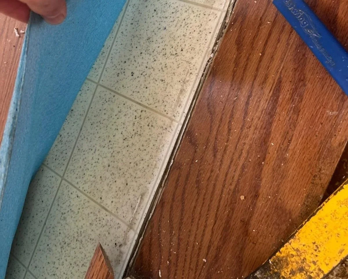 Vinyl flooring was found under the damaged laminate during a water damage restoration