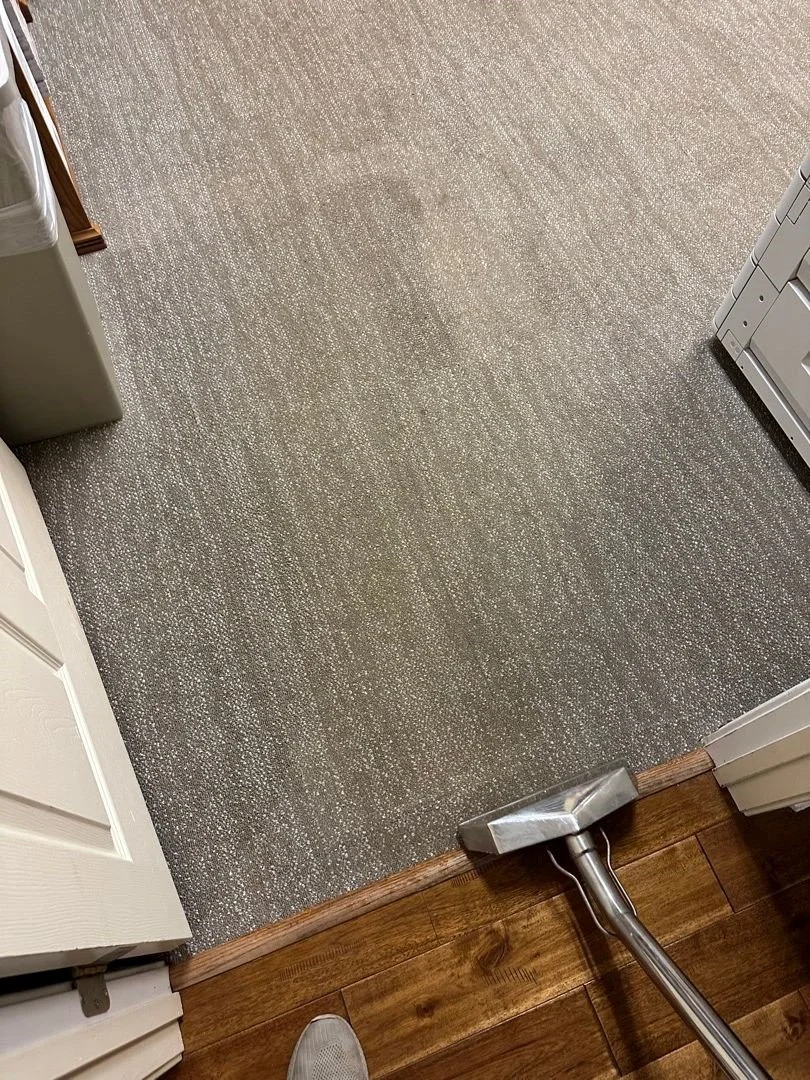 ServiceMaster technician using cleaning wand to clean carpet