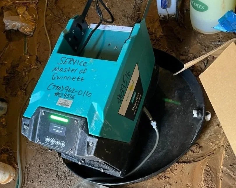 ServiceMaster dehumidifier drying crawlspace after water main break