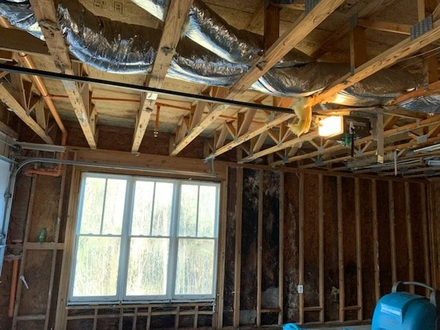 ServiceMaster removed damged drywall and insulation from ceiling and walls of this garage then set equipment to dry it out