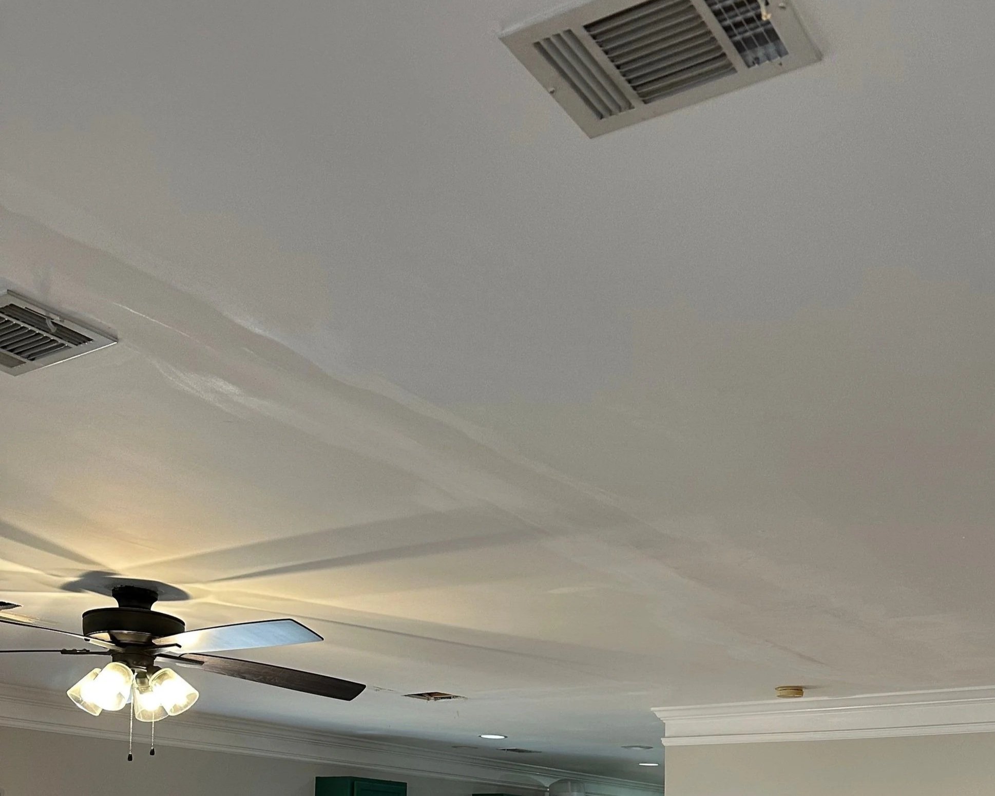 Water damage on living room ceiling from toilet supply line leak in bathroom above