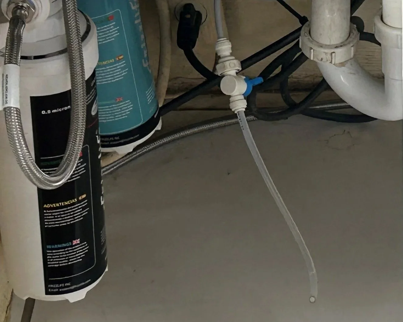 Water filter hose that leaked under the kitchen sink causing water damage