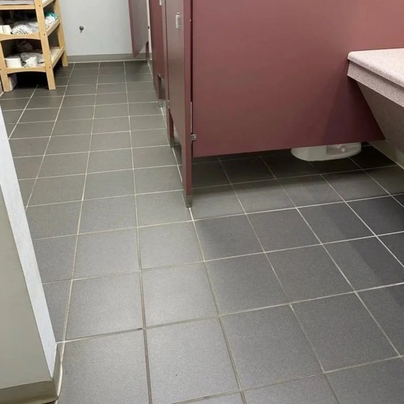 Bathroom tile floor before ServiceMaster maintenance cleaning