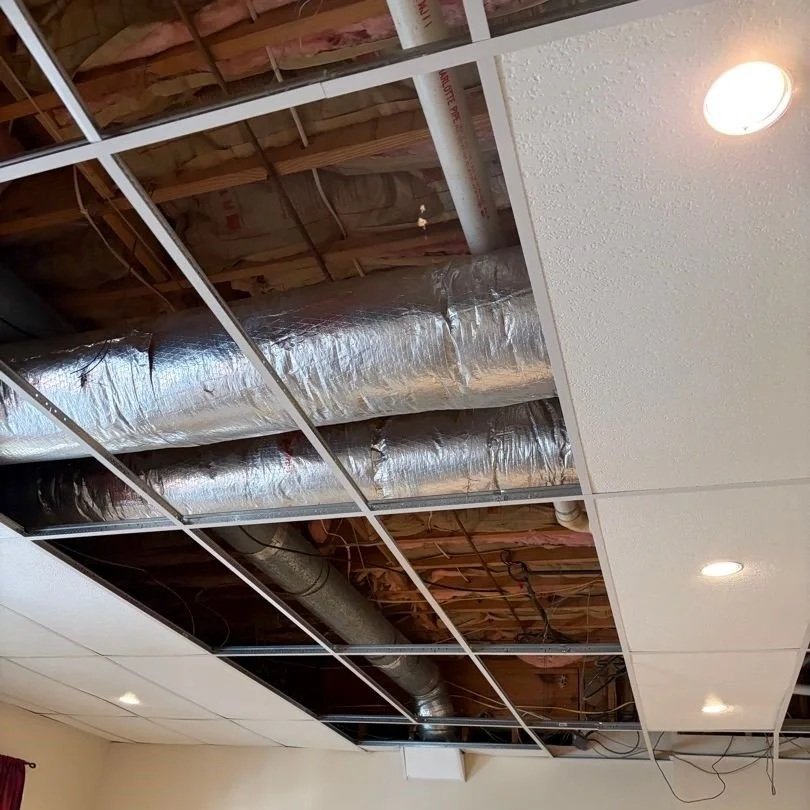 Damaged ceiling tiles removed from basement bedroom