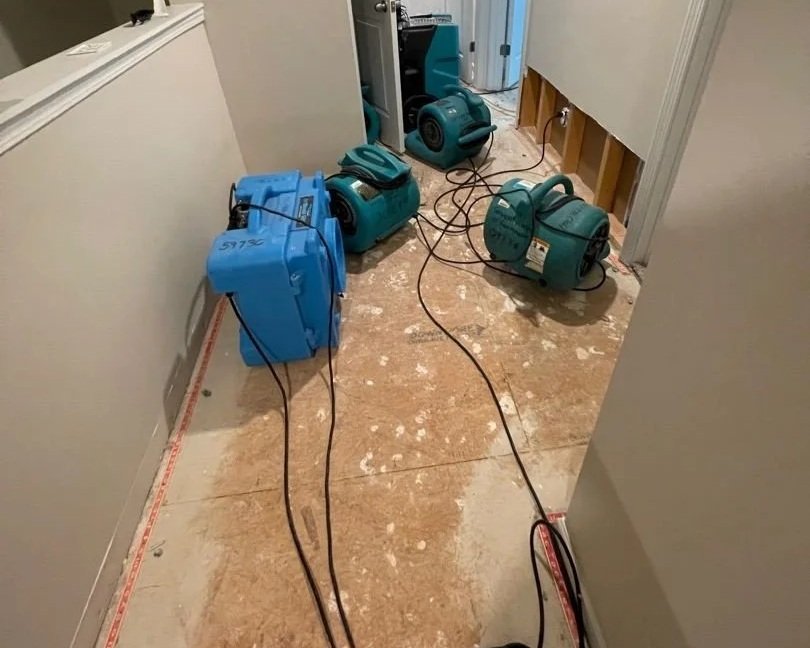 Hallway after damaged drywall and carpet were removed and drying equipment was set by ServiceMaster
