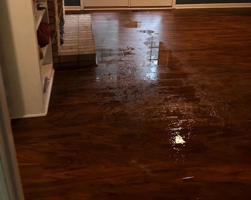 Wet floor from water damage in family room
