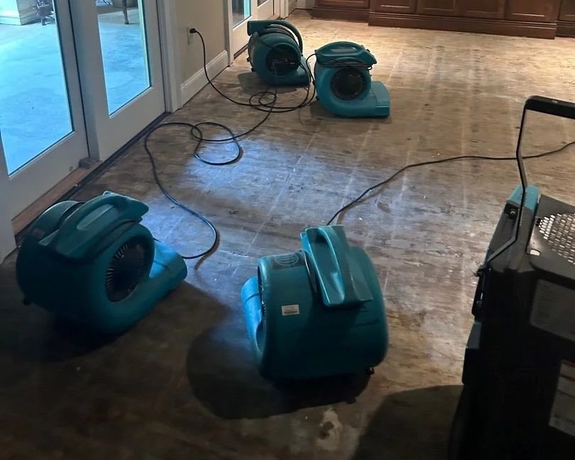 Air movers and dehumidifier set by ServiceMaster to dry out the basement living room