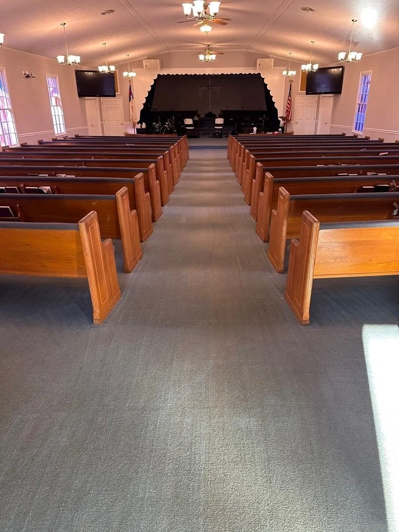 View of carpet and pews from back of sanctuary after ServiceMaster carpet and upholstery cleaning