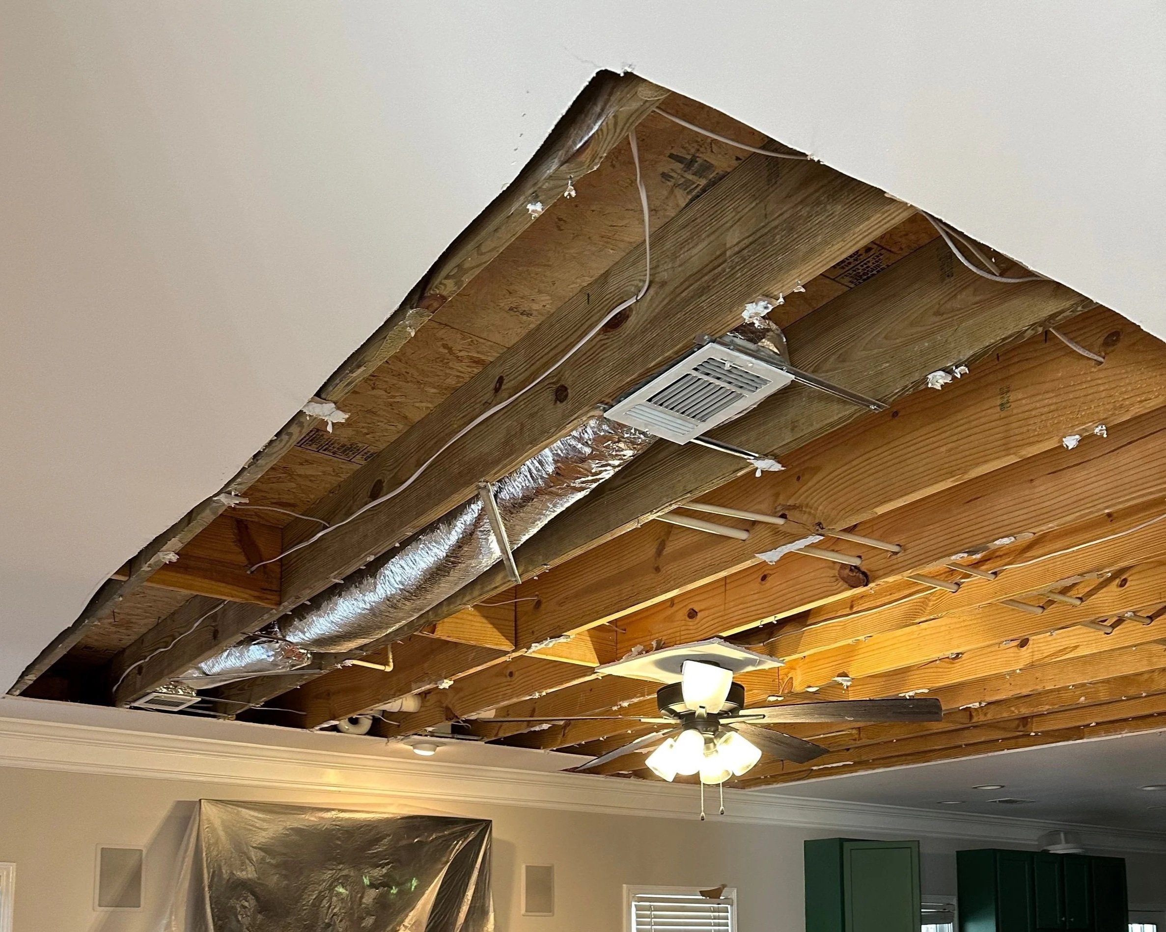 Damaged drywall removed from the living room ceiling