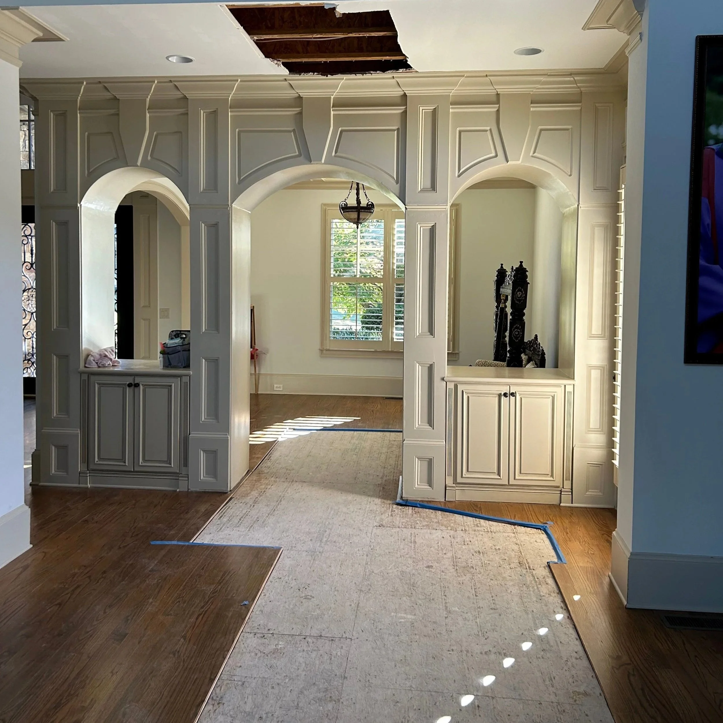 Damaged ceiling drywall and hardwood flooring removed by ServiceMaster after 2nd floor bathtub overflowed
