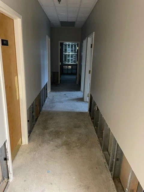 Hallway after ServiceMaster removed debris, wet carpet and wet drywall then dried the room